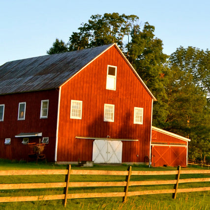 Pole BarnsA red barn at sunset.
