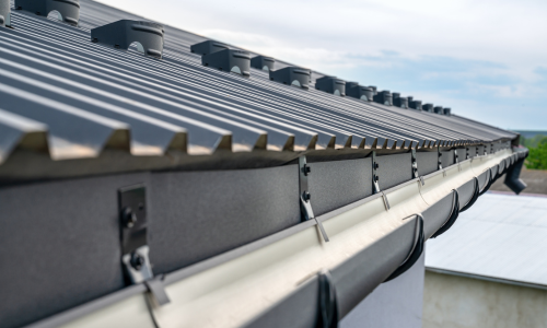 A close-up of a metal roof and gutter.